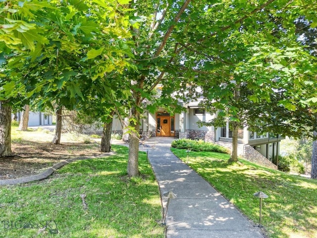 953 Angel Point Rd, Lakeside, MT 59922 - view of property hidden behind natural elements with stone siding and a front lawn