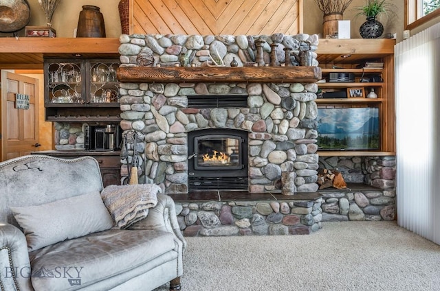 953 Angel Point Rd, Lakeside, MT 59922 - living room featuring carpet, a stone fireplace, and wooden ceiling
