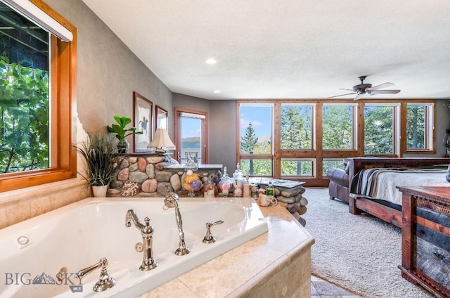 953 Angel Point Rd, Lakeside, MT 59922 - ensuite bathroom featuring a jetted tub, ceiling fan, a textured ceiling, and recessed lighting