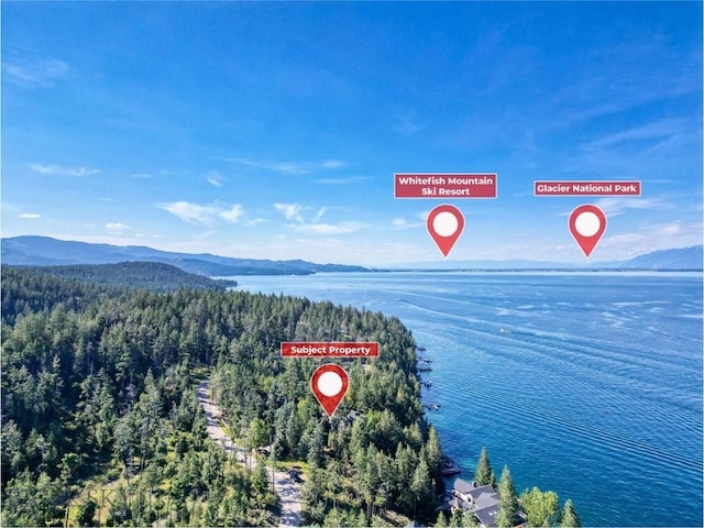 953 Angel Point Rd, Lakeside, MT 59922 - bird's eye view of a heavily wooded area and a water and mountain view
