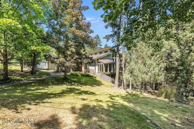 953 Angel Point Rd, Lakeside, MT 59922 - view of grassy yard featuring a sunroom and stairs