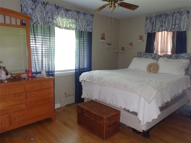 120 Balsam St, Anaconda, MT 59711 - bedroom featuring multiple windows, wood finished floors, baseboard heating, and ceiling fan