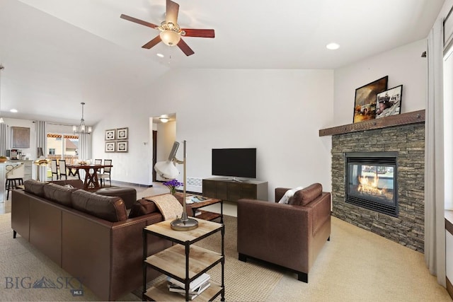 343 Stewart Loop, Bozeman, MT 59718 - living area featuring ceiling fan, light carpet, a stone fireplace, lofted ceiling, and a chandelier