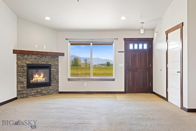 343 Stewart Loop, Bozeman, MT 59718 - entryway with carpet floors, a mountain view, a stone fireplace, and recessed lighting