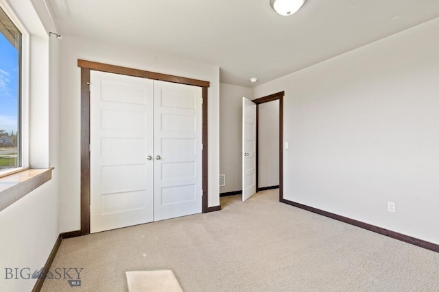 343 Stewart Loop, Bozeman, MT 59718 - unfurnished bedroom with light colored carpet, multiple windows, and a closet