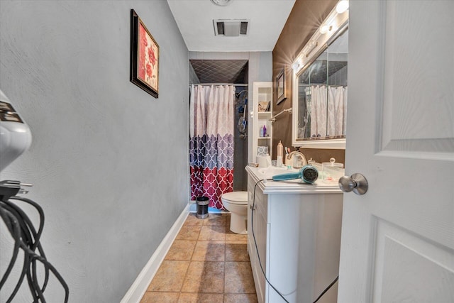 bathroom featuring toilet, vanity, and tile flooring