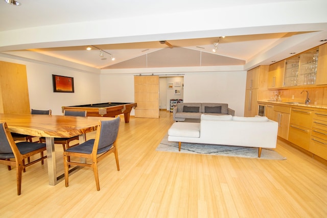 dining space featuring light hardwood / wood-style floors, vaulted ceiling, rail lighting, pool table, and sink