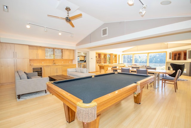 game room featuring wine cooler, light wood-type flooring, rail lighting, and pool table