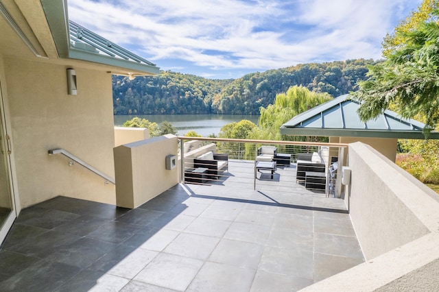 view of patio / terrace featuring a balcony and a water view