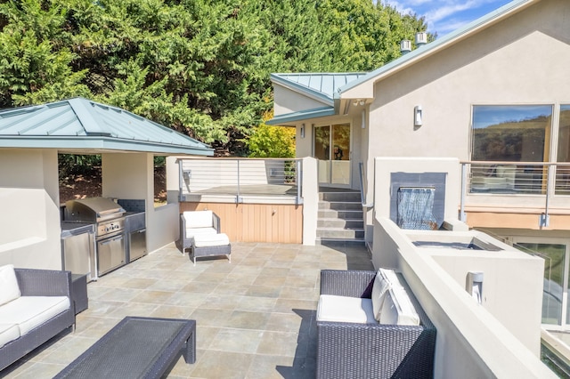 view of patio with an outdoor kitchen, outdoor lounge area, a grill, and a hot tub