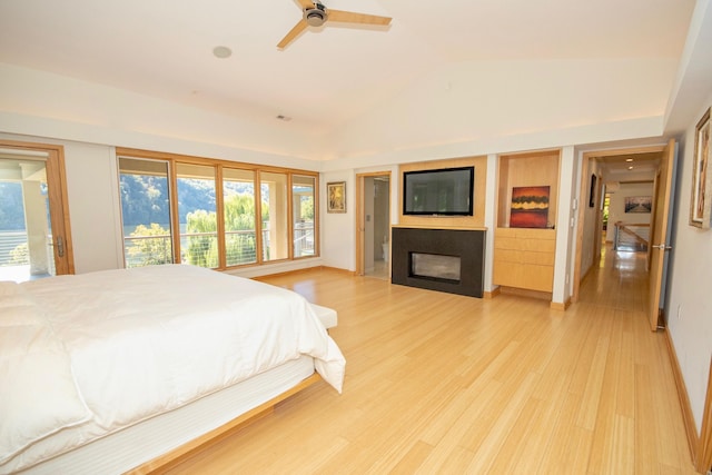 bedroom with light hardwood / wood-style flooring, multiple windows, and lofted ceiling