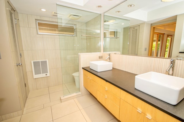 bathroom with an enclosed shower, vanity, tile walls, tile flooring, and toilet