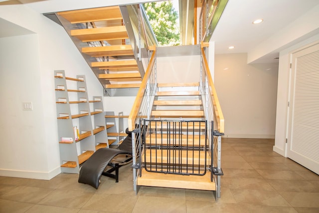 staircase with light tile floors