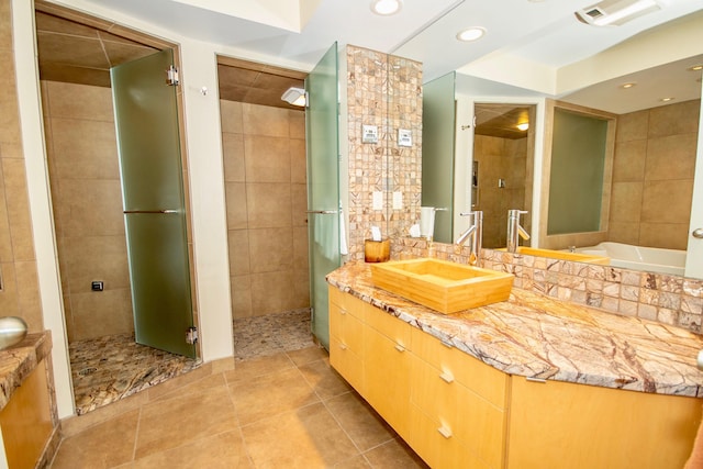 bathroom with tile walls, tile floors, vanity, and plus walk in shower