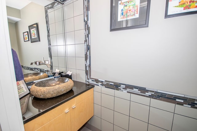 bathroom featuring tile walls and vanity