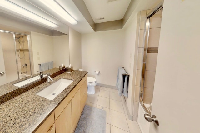 bathroom featuring oversized vanity, toilet, and tile flooring