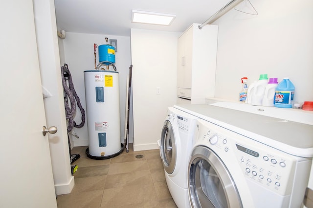 clothes washing area with washer and dryer, electric water heater, and light tile floors