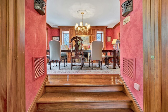 staircase featuring carpet flooring and an inviting chandelier