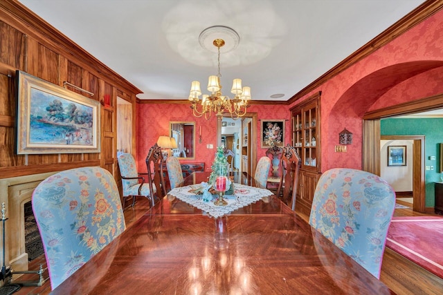 dining space featuring an inviting chandelier, dark parquet floors, and ornamental molding