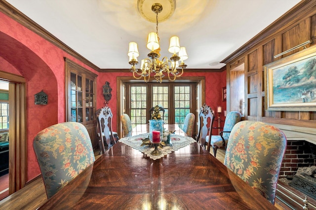 dining space with crown molding, dark parquet floors, and a chandelier