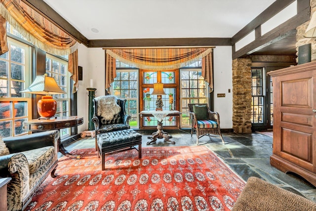 living area with beamed ceiling