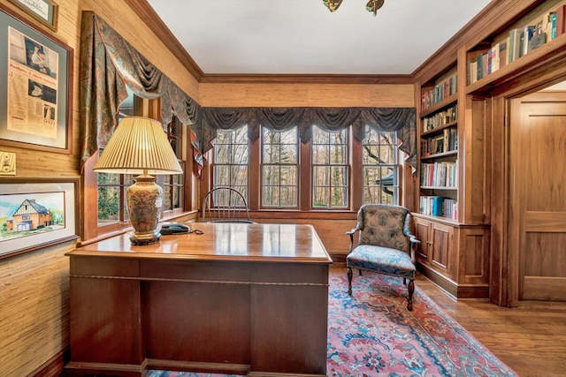 office with crown molding, built in shelves, and hardwood / wood-style flooring