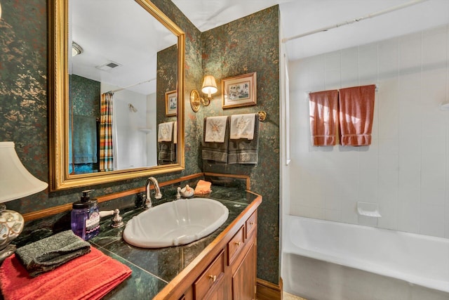 bathroom featuring vanity and shower / tub combo with curtain