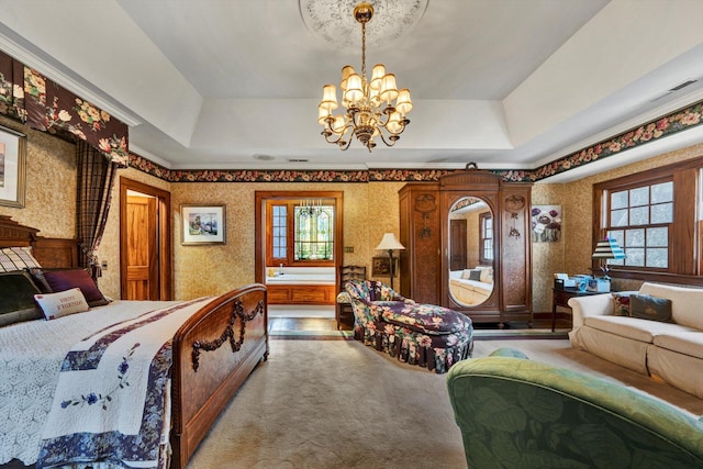 bedroom featuring a notable chandelier, a raised ceiling, and multiple windows