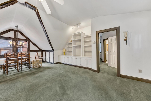 bonus room featuring dark colored carpet, ceiling fan with notable chandelier, and vaulted ceiling