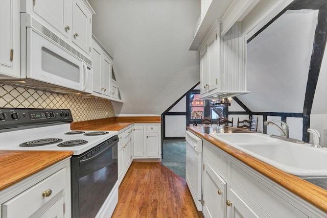 kitchen with light wood-type flooring, tasteful backsplash, white appliances, sink, and white cabinets