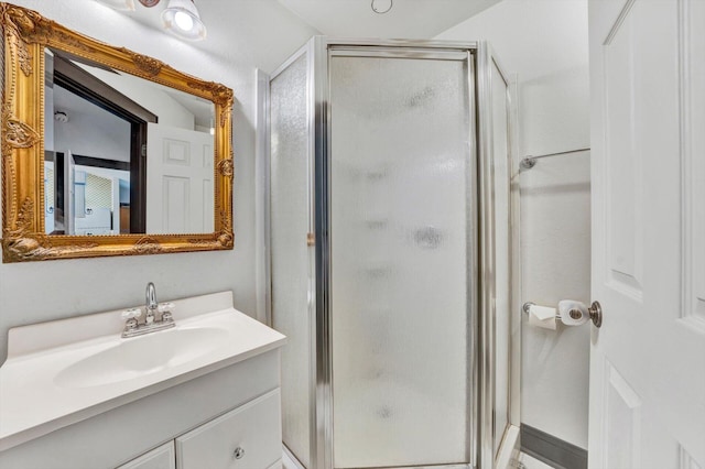 bathroom with large vanity and an enclosed shower