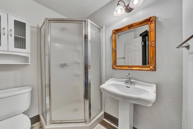 bathroom with toilet, a shower with door, and tile floors