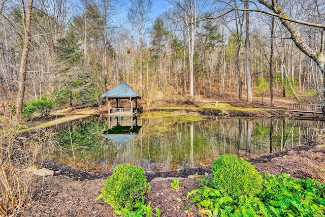 view of dock with a gazebo and a water view