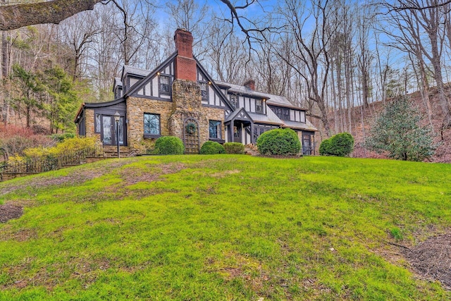 english style home with a front yard