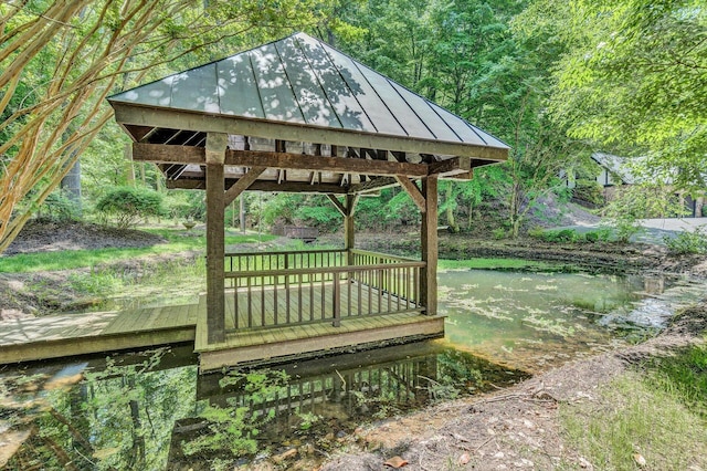 deck featuring a gazebo and a water view