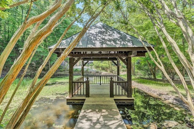 surrounding community featuring a gazebo and a water view