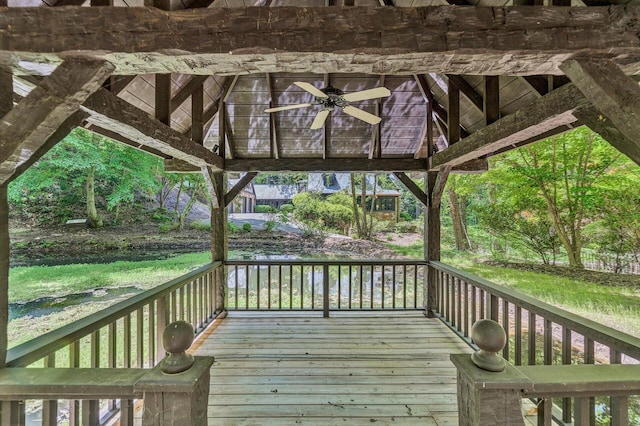 wooden terrace featuring ceiling fan