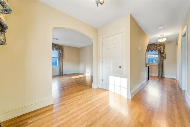 unfurnished room with light wood-type flooring