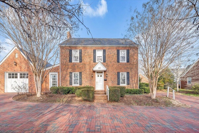 colonial inspired home featuring a garage