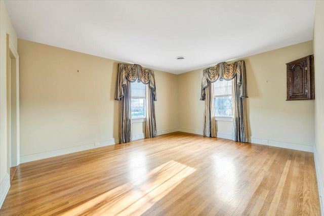 empty room with light hardwood / wood-style flooring