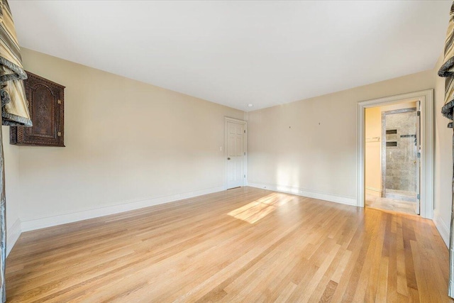 unfurnished room with light wood-type flooring