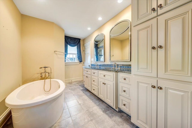 bathroom with tile flooring, a bathing tub, and oversized vanity