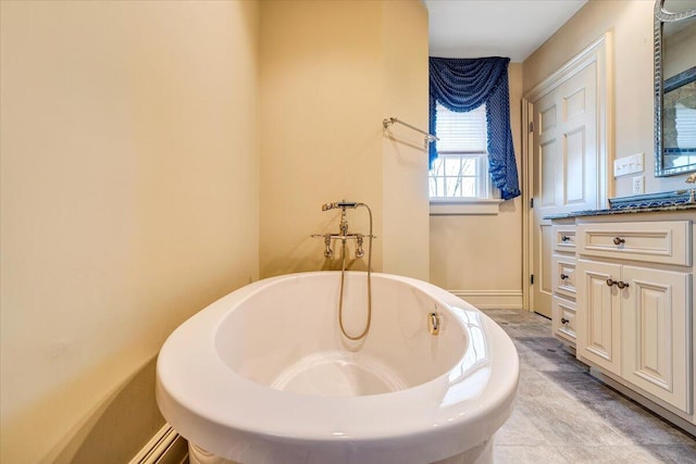 bathroom featuring vanity, a washtub, and tile floors