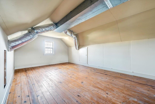 additional living space with lofted ceiling and light wood-type flooring