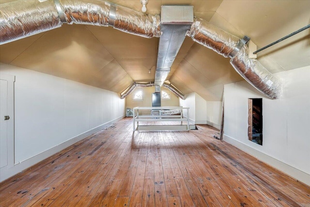 bonus room with lofted ceiling and hardwood / wood-style floors