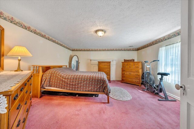 carpeted bedroom featuring a textured ceiling