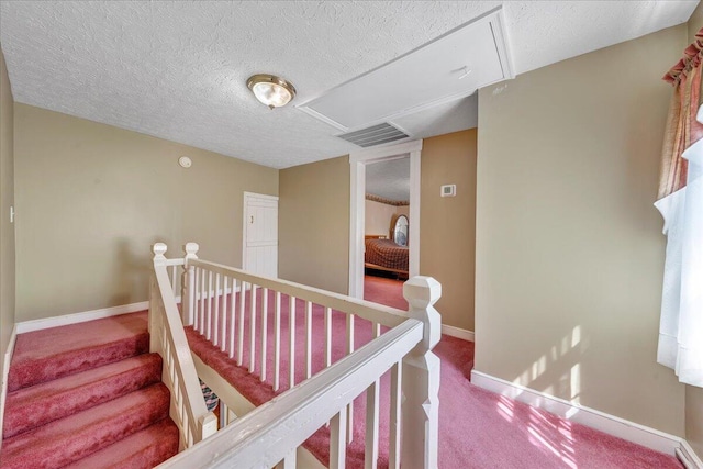 interior space with a textured ceiling and carpet