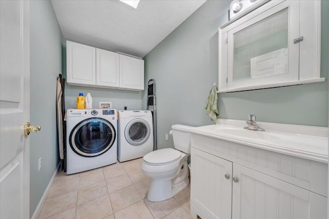 laundry area featuring light tile floors, hookup for a washing machine, independent washer and dryer, a textured ceiling, and sink