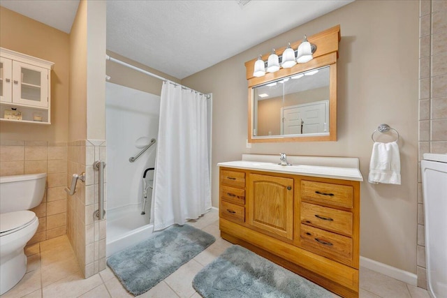 bathroom with toilet, vanity, a shower with curtain, tile walls, and tile floors