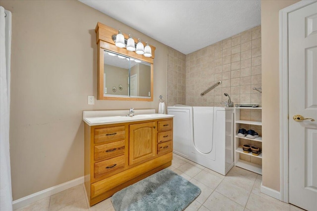 bathroom featuring a textured ceiling, tile floors, and vanity